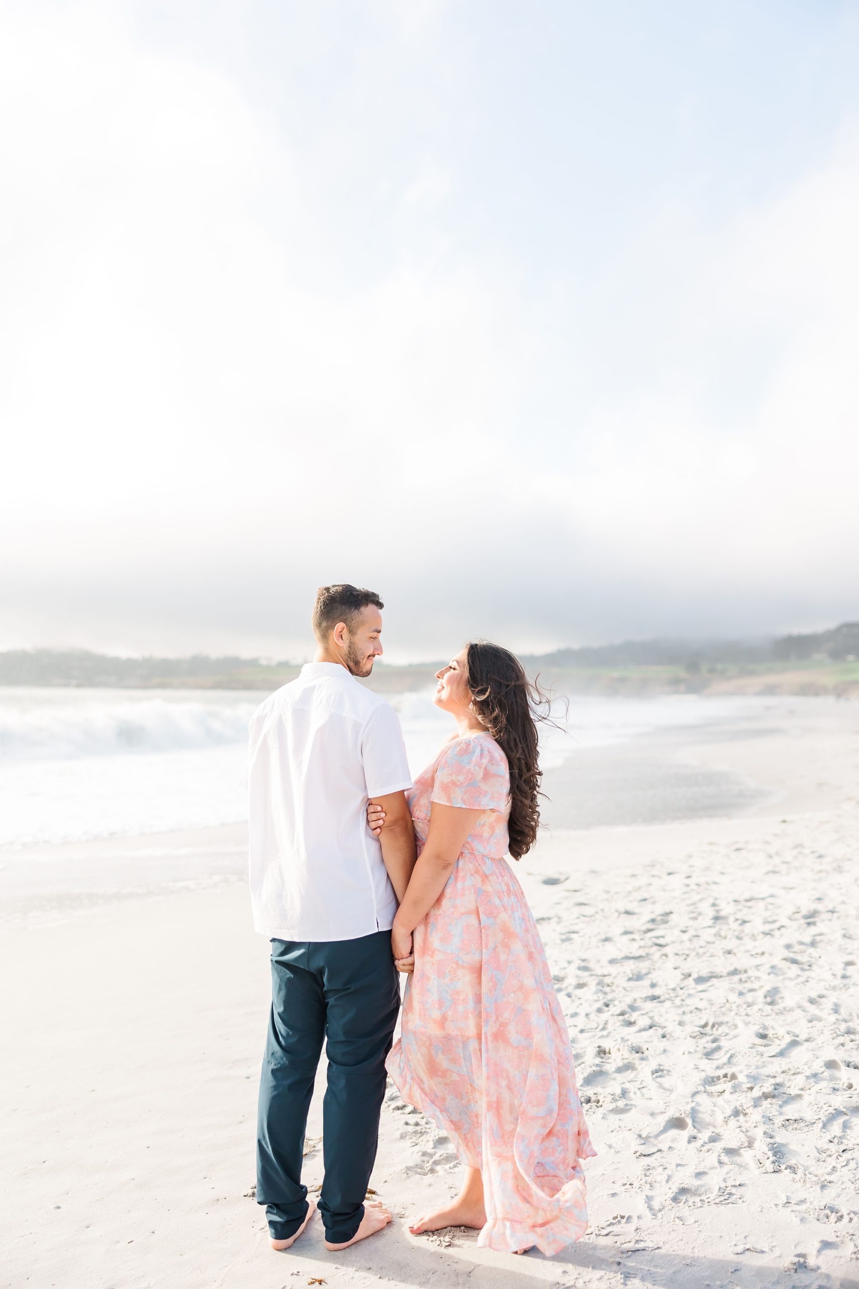beautiful beach photo of couple holding hands on beach