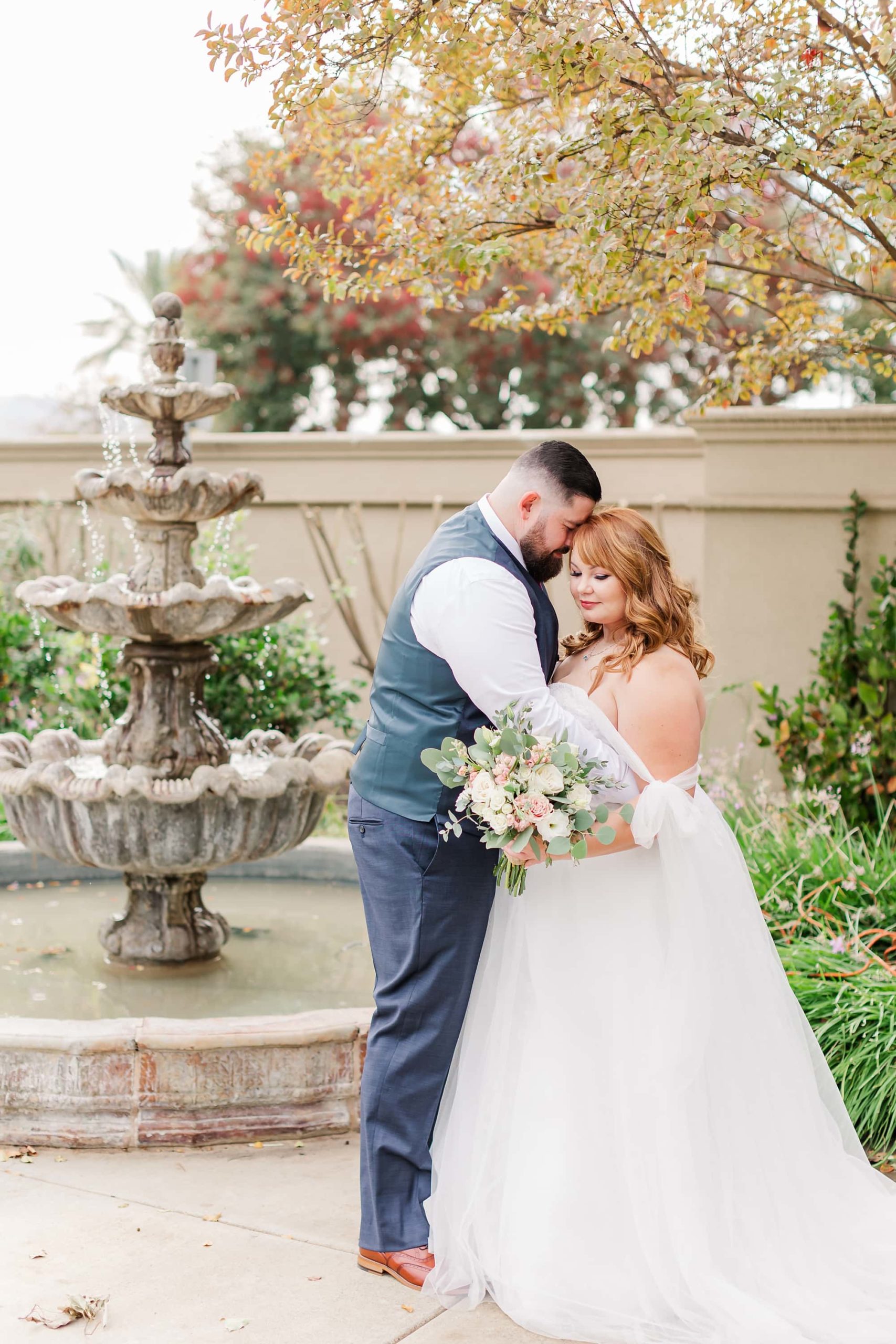 romantic bride and groom portrait by fountain