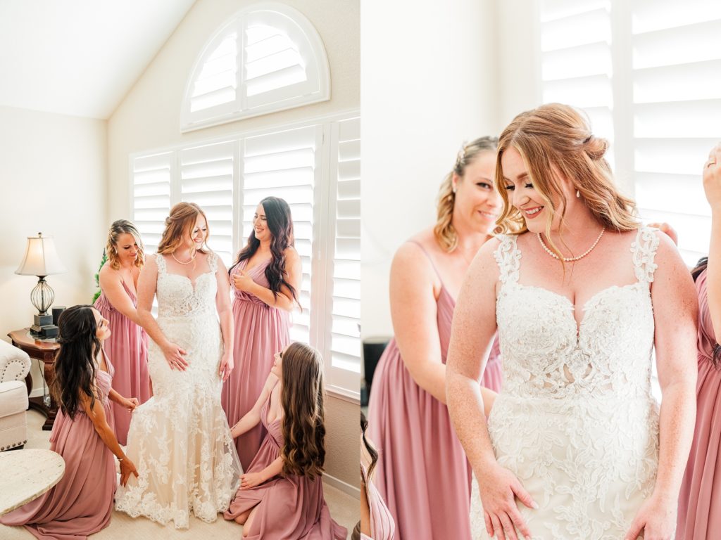 Bride getting in her dress with her bridesmaids