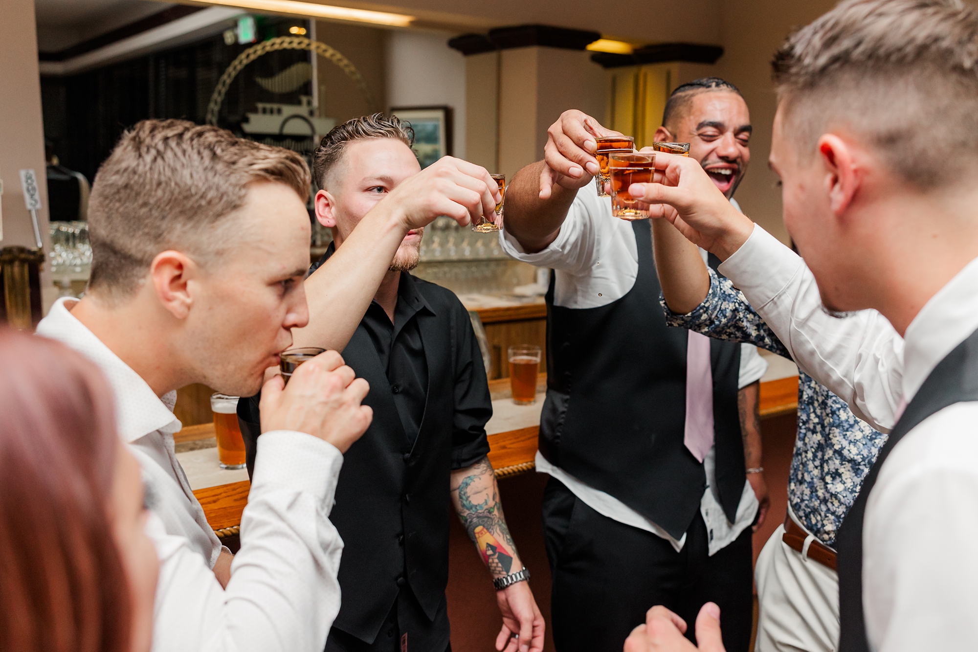 groom taking a shot with his friends