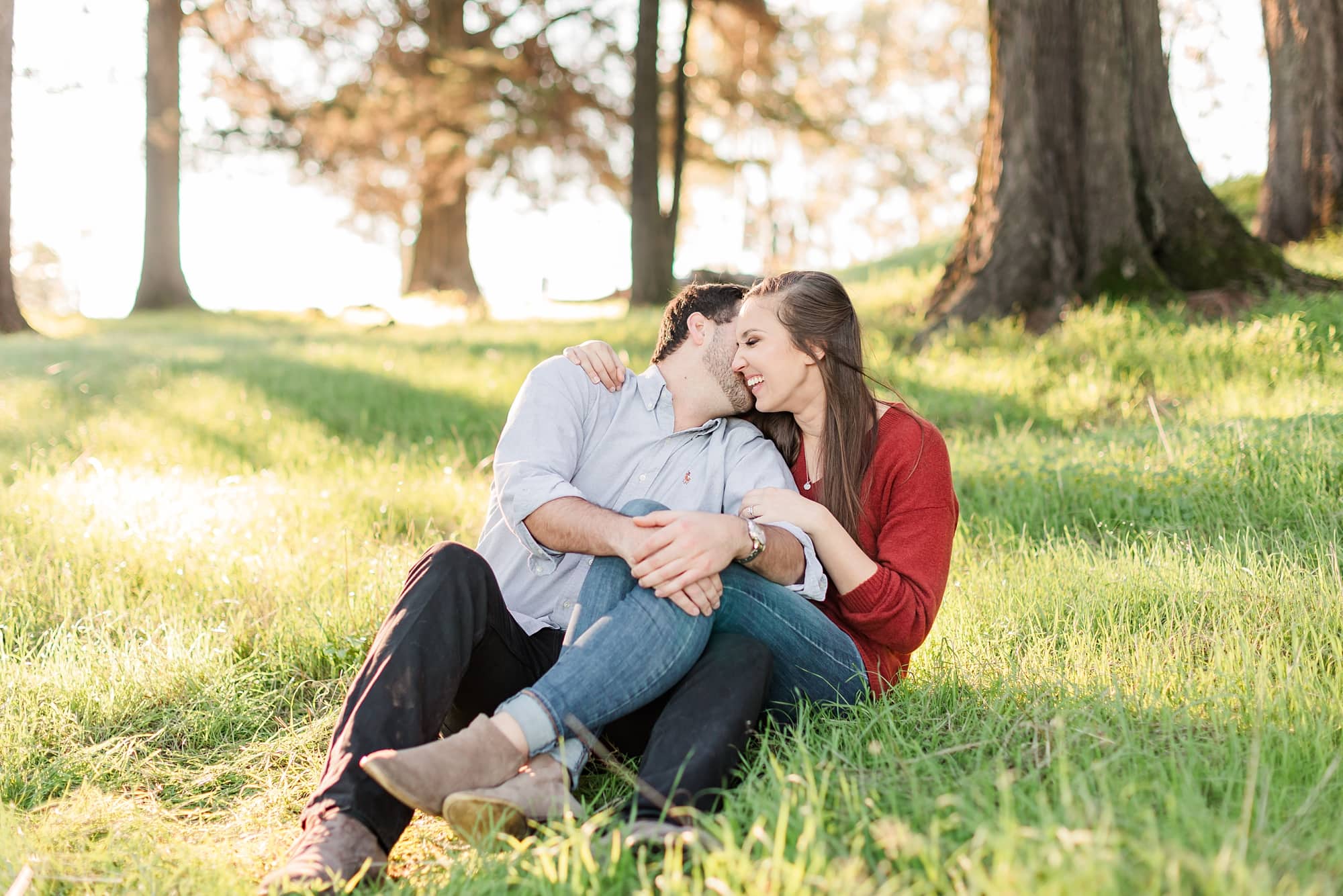 couple sitting on the grass for engagement photos