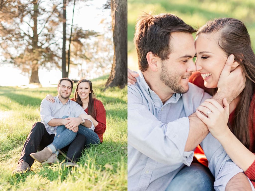 couple sitting in a field for engagement photos