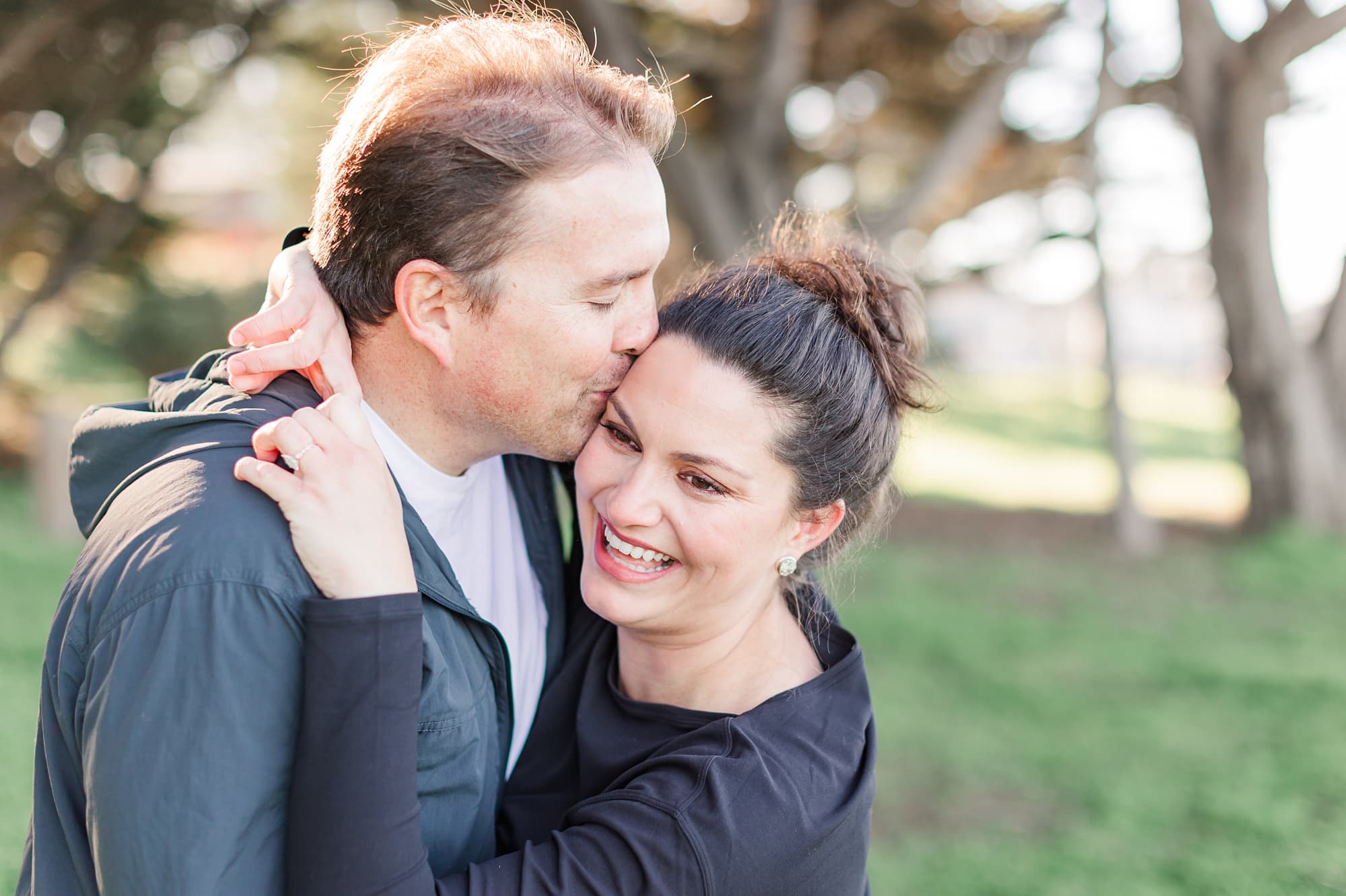 guy kissing girl on the cheek pose at engagement session