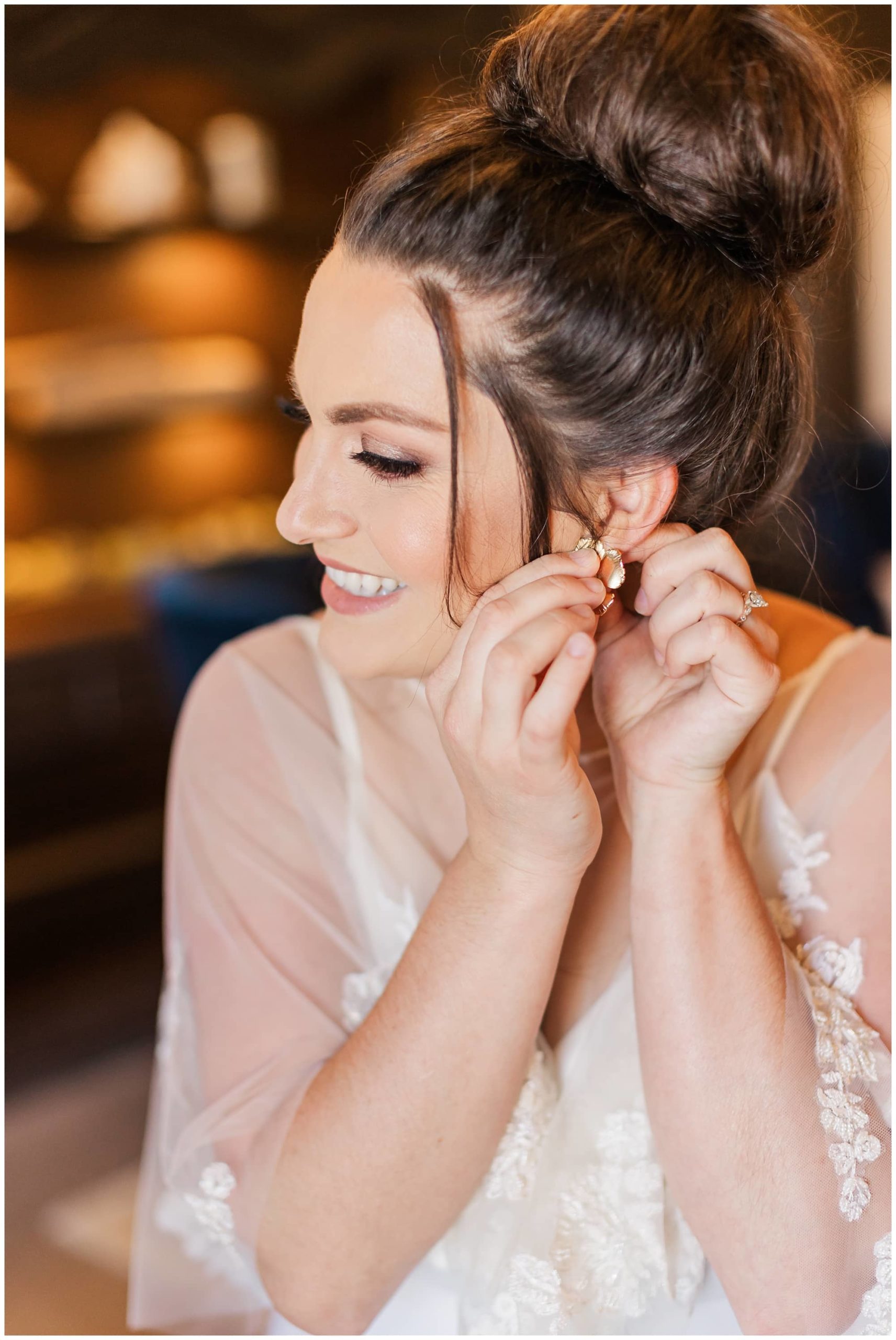 bride putting jewelry on photos