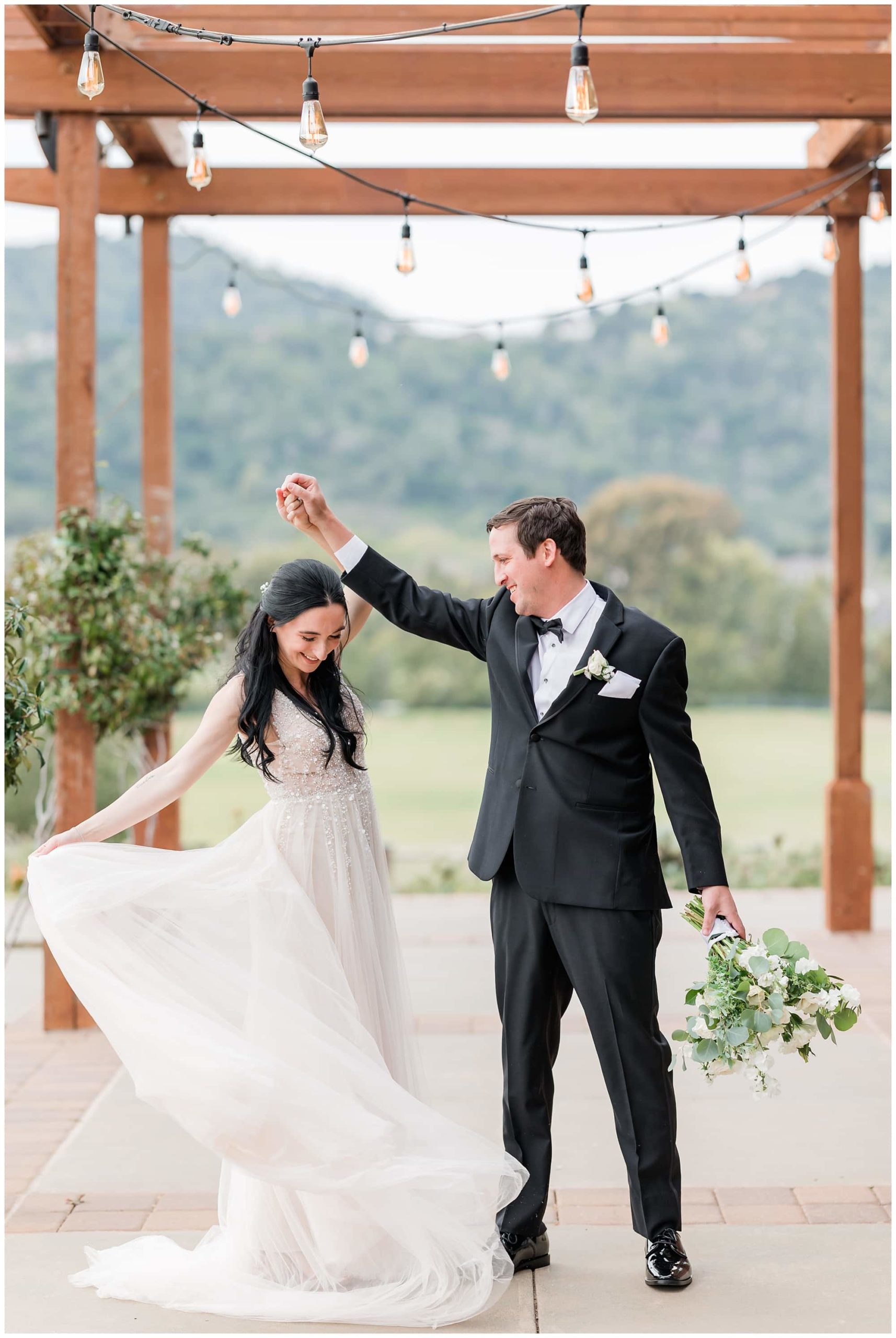 bride and groom twirl pose photos