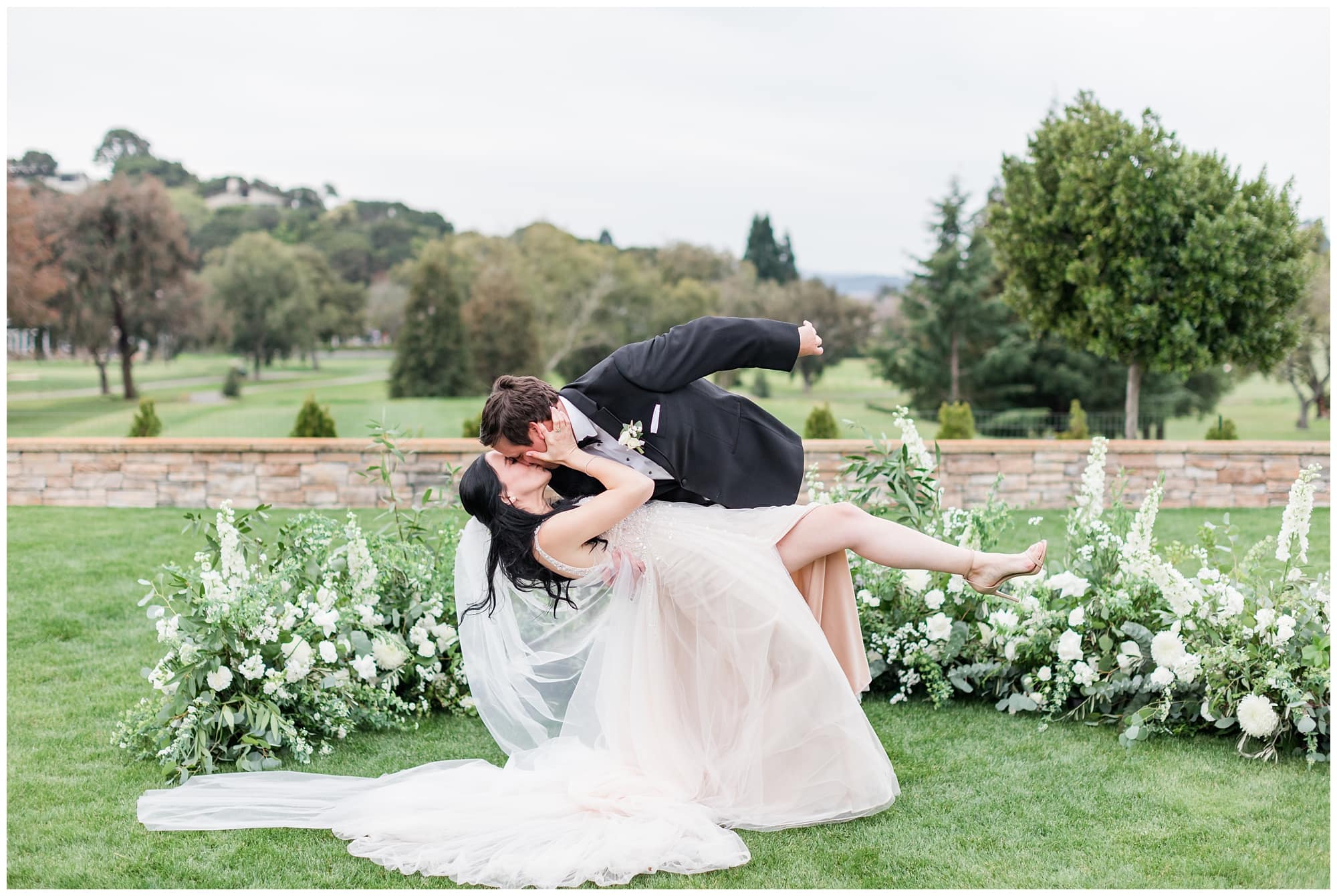 bride and groom dip kiss pose on wedding day