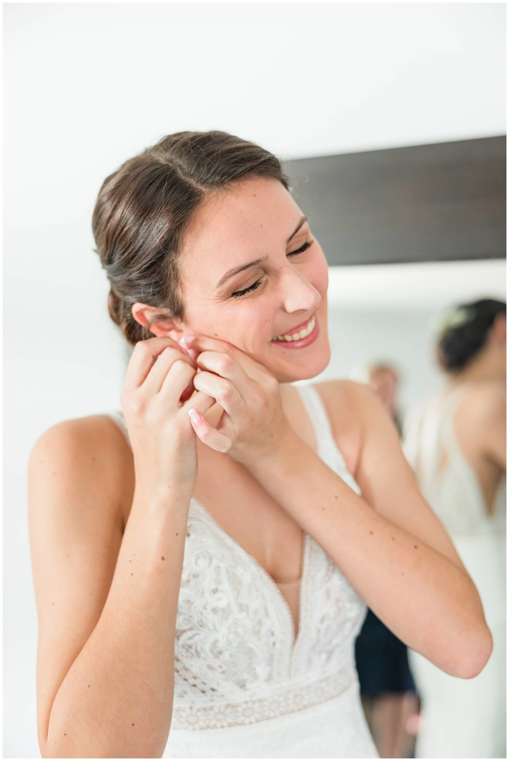 bride putting earrings on photo