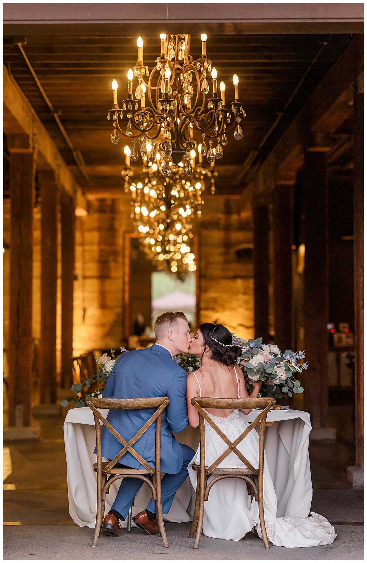 BRIDE AND GROOM KISSING AT SWEETHEART TABLE