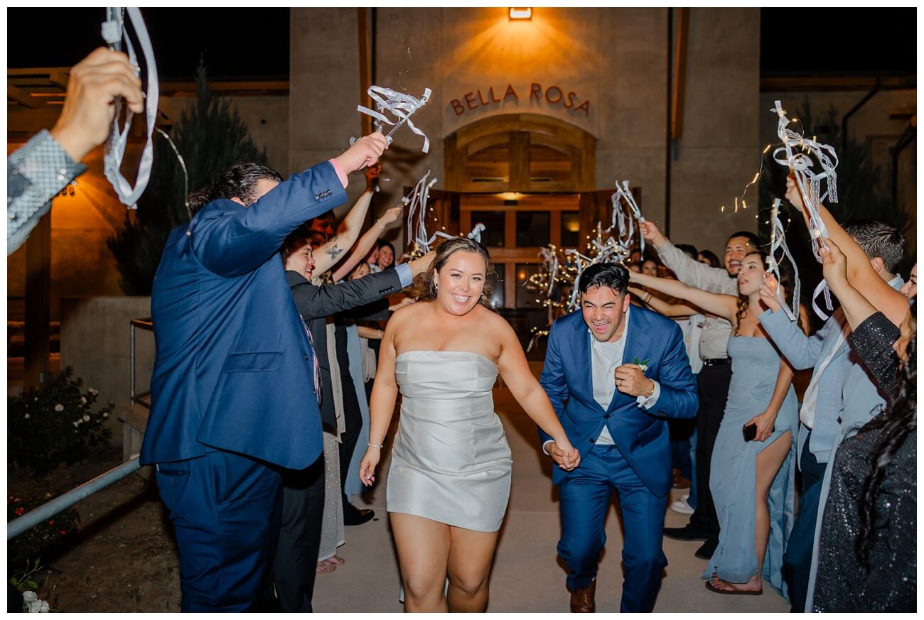 Bride and groom grand exit with ribbon wands at night outside Garre winery wedding Livermore CA
